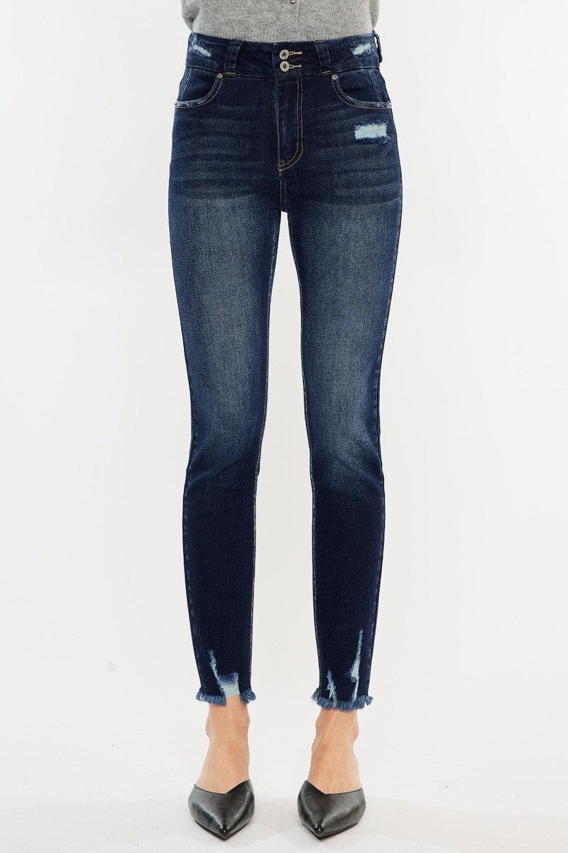 a woman in a gray sweater and jeans