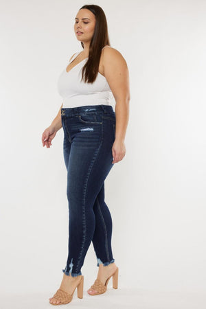 a woman in a white tank top and jeans
