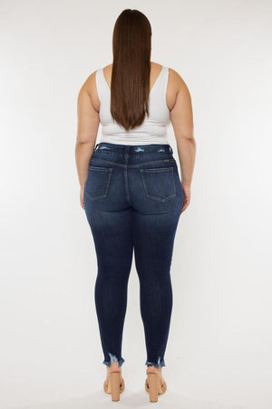 a woman in a white tank top and jeans
