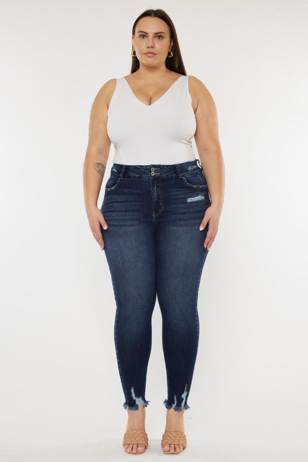 a woman in a white top and jeans