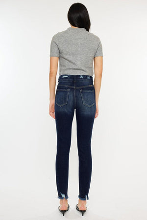 a woman in a grey shirt and jeans