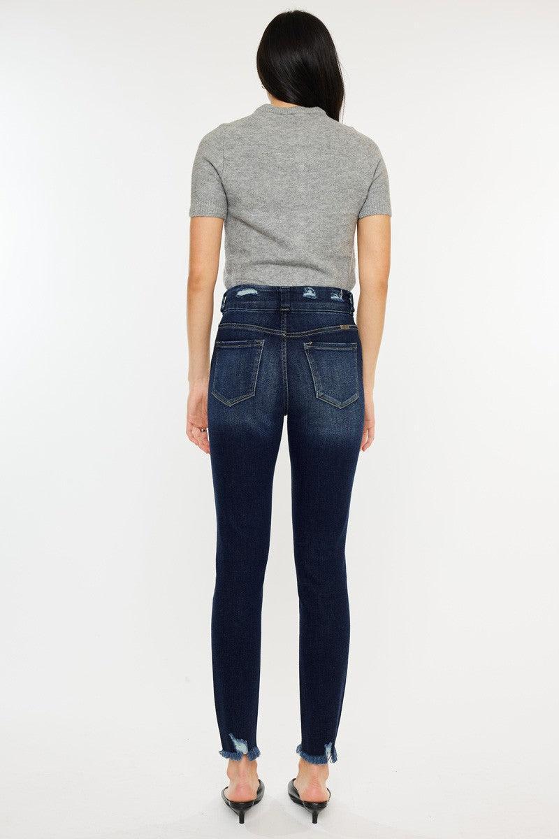 a woman in a grey shirt and jeans