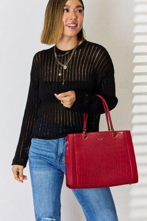 a woman holding a red purse and smiling