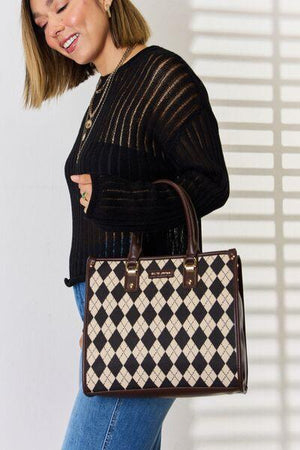 a woman holding a brown and white purse