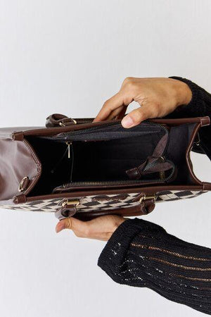 a woman is holding a brown purse
