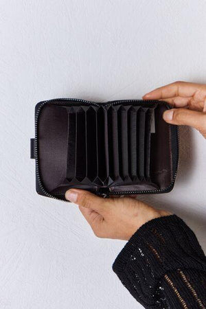 a person holding a wallet in their hand