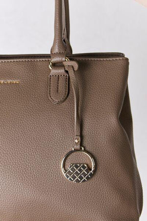 a brown purse with a metal ring on the handle