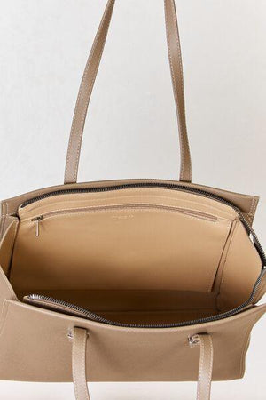 a beige handbag with a zippered closure