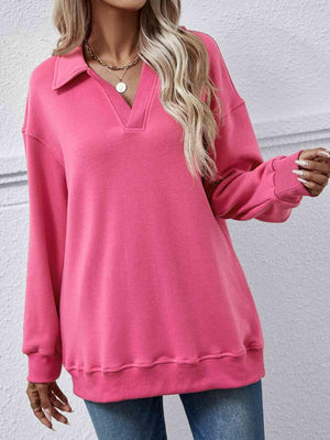 a woman wearing a pink sweater and jeans