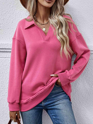a woman wearing a pink sweater and hat