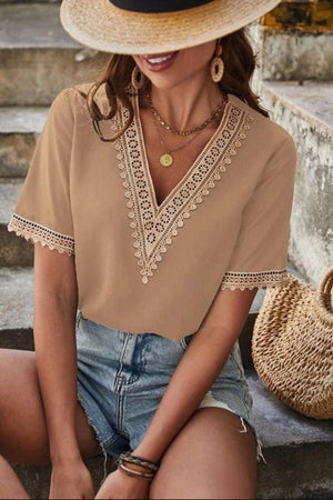 a woman sitting on the steps wearing a hat