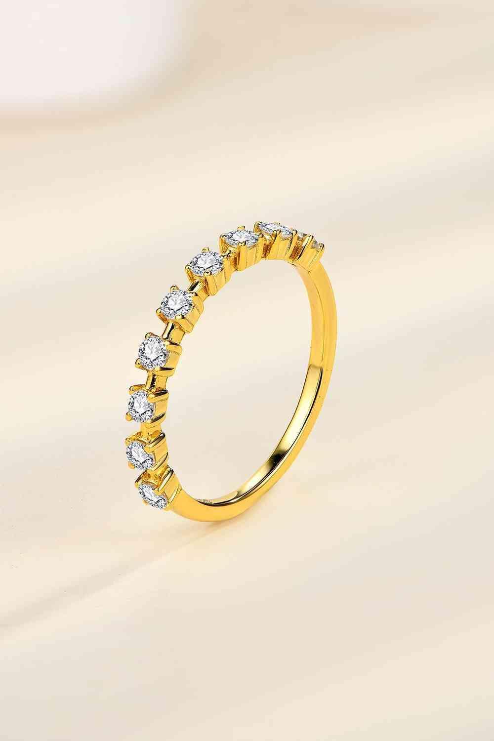 a yellow gold wedding band with five diamonds