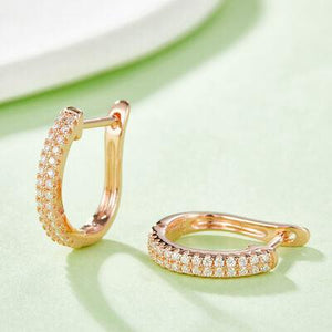 a pair of diamond hoop earrings on a table