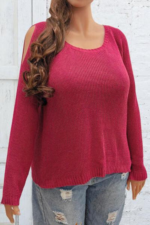 a mannequin wearing a red sweater and jeans