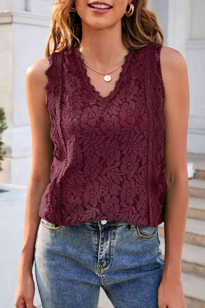 a woman wearing a burgundy top and jeans
