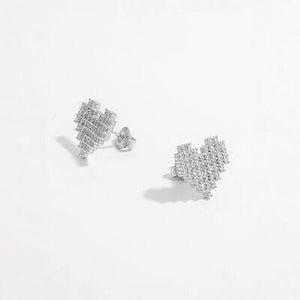 a pair of diamond earrings on a white background