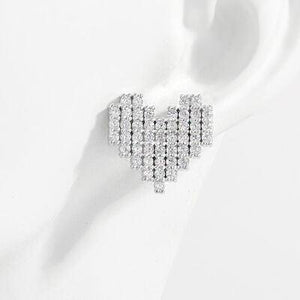 a pair of diamond earrings on a white background