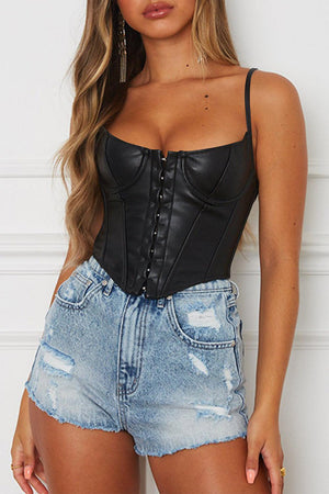 a woman wearing a black corset and denim shorts