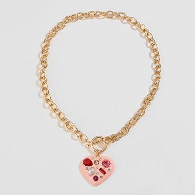 a gold chain bracelet with a pink heart charm
