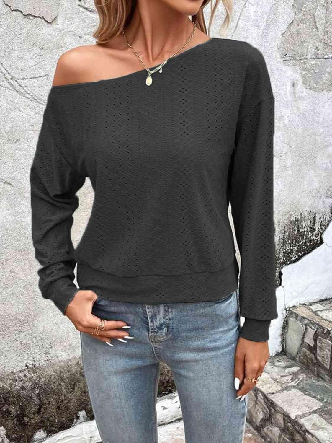 a woman wearing a black sweater and jeans
