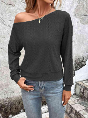 a woman wearing a black sweater and jeans