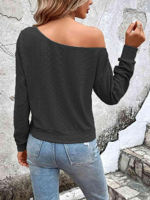 a woman wearing a black sweater and jeans