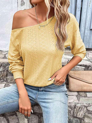 a woman wearing a yellow sweater and jeans