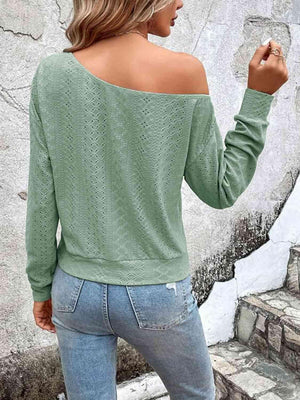 a woman wearing a green sweater and jeans