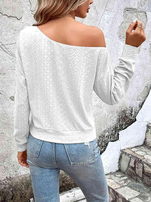 a woman wearing a white sweater and jeans