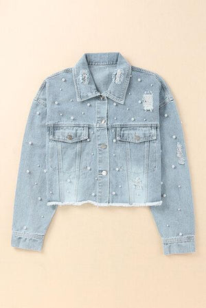 a denim jacket with holes and pearls on it
