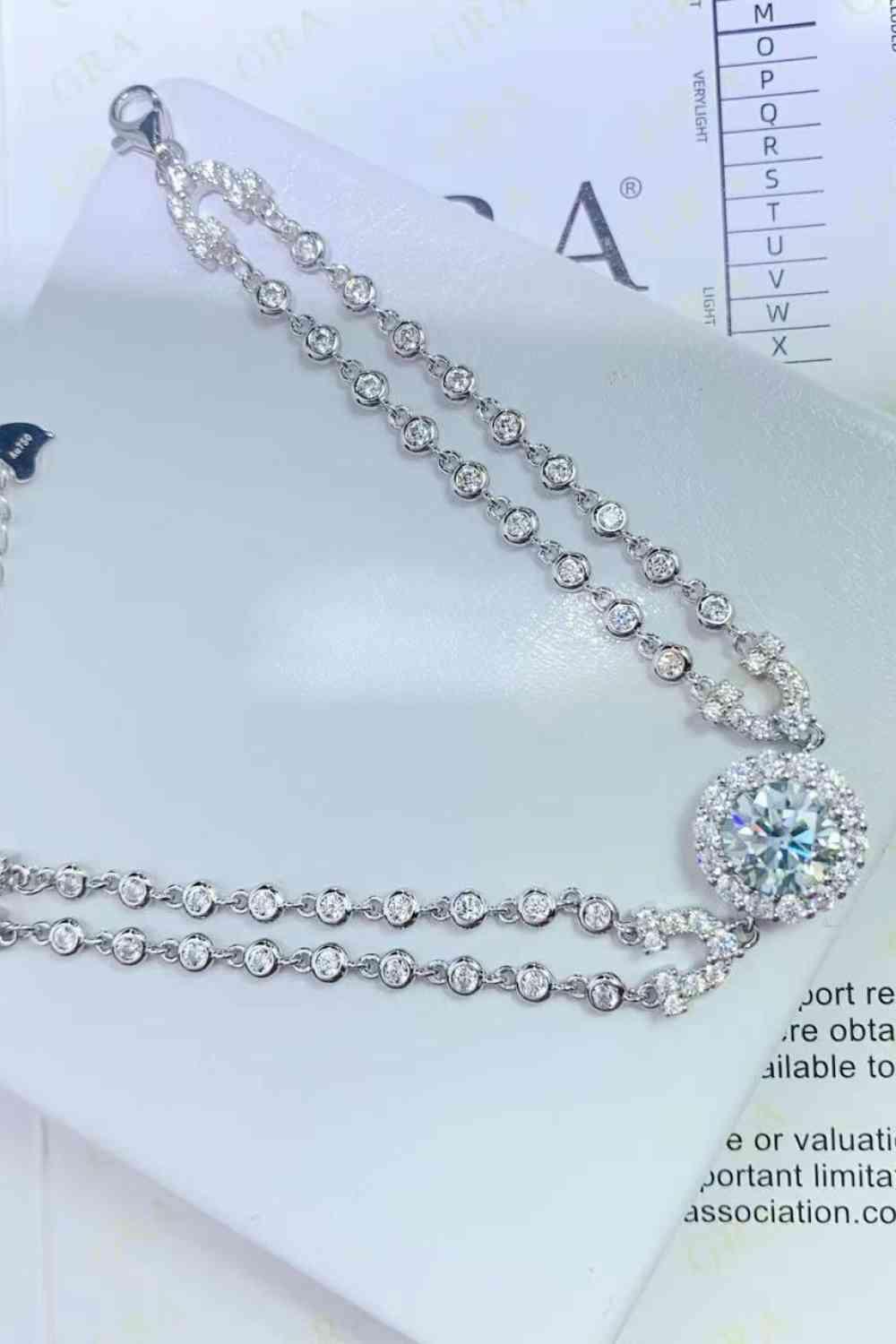 a necklace with a diamond on top of it