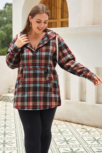 a woman in a plaid shirt walking down a sidewalk