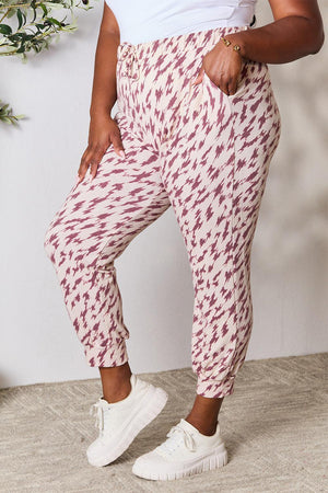 a woman in white shirt and red patterned pants