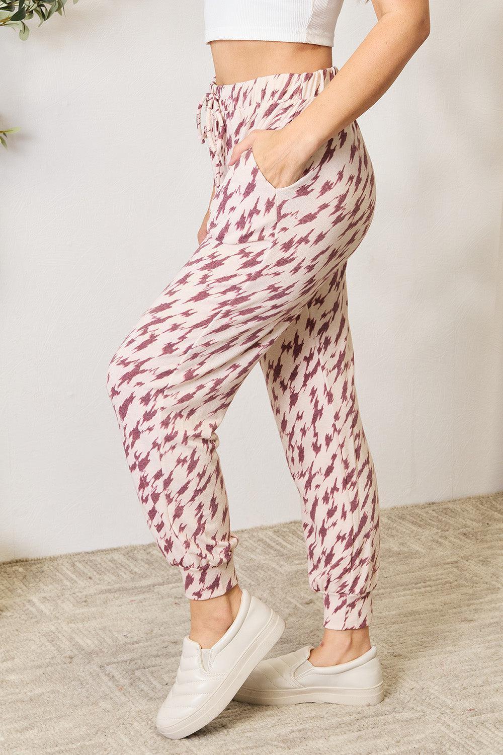 a woman in a white top and patterned pants