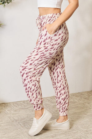 a woman in a white top and patterned pants