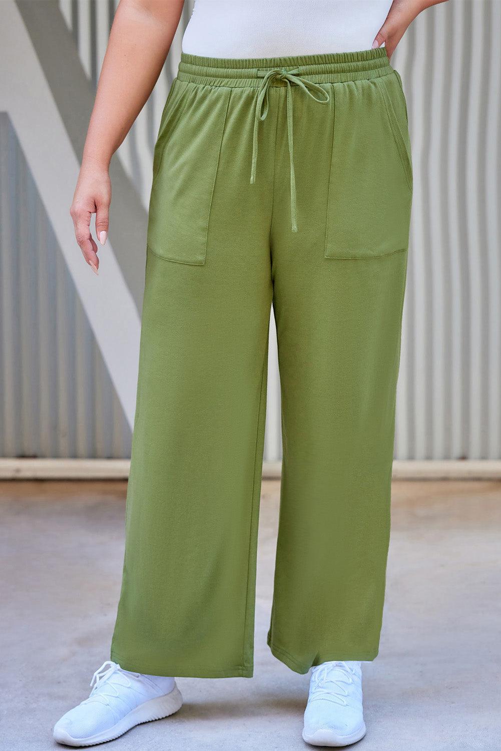 a woman in a white shirt and green pants