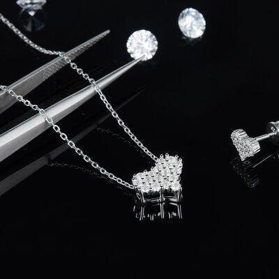 a pair of scissors and some jewelry on a black background