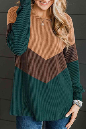 a woman wearing a green and brown striped sweater