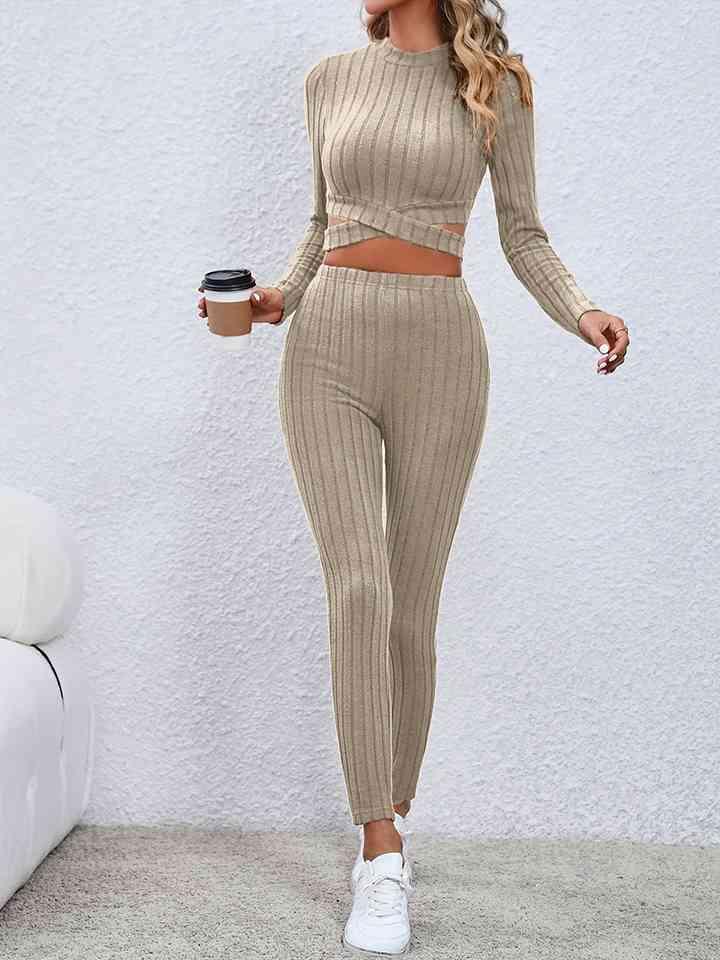 a woman in a tan outfit holding a cup of coffee