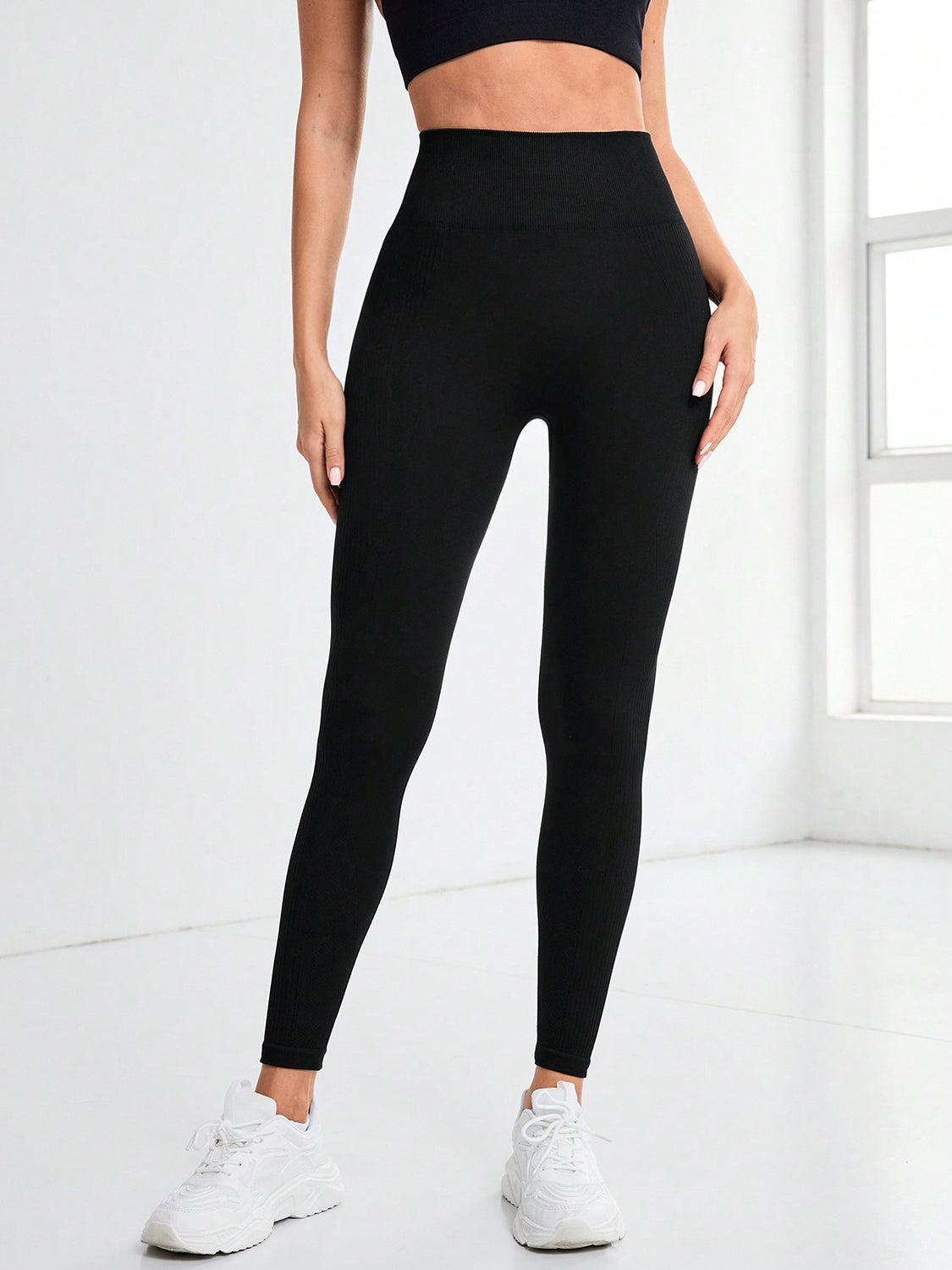 a woman in black sports bra top and leggings