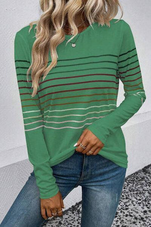 a woman wearing a green striped top