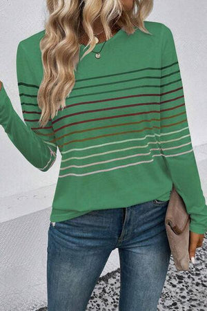 a woman wearing a green striped sweater