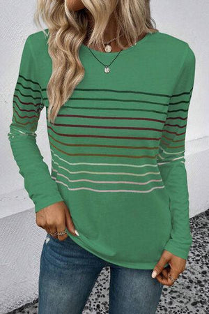 a woman wearing a green striped top