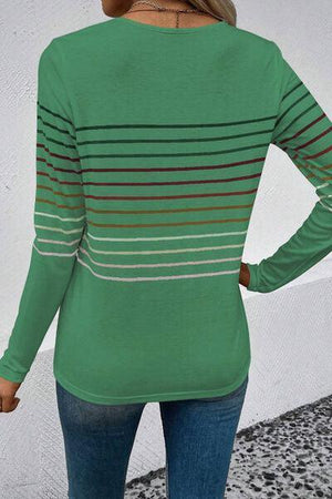 a woman wearing a green striped sweater