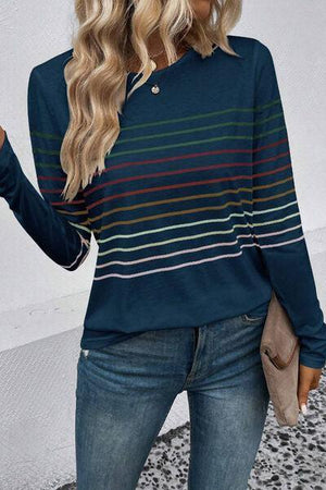 a woman wearing a blue striped sweater and jeans