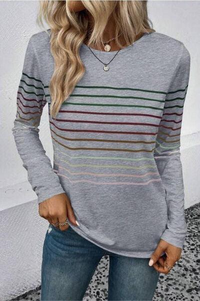 a woman wearing a grey striped sweater