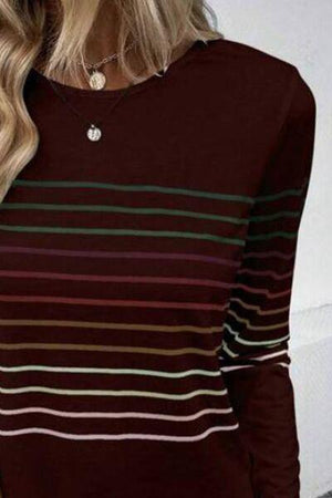 a woman with blonde hair wearing a striped sweater