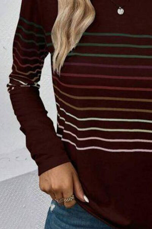 a woman wearing a brown and green striped sweater