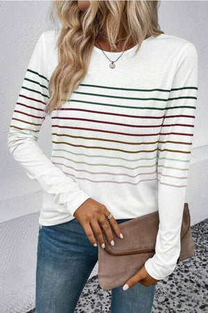 a woman wearing a white striped sweater and jeans