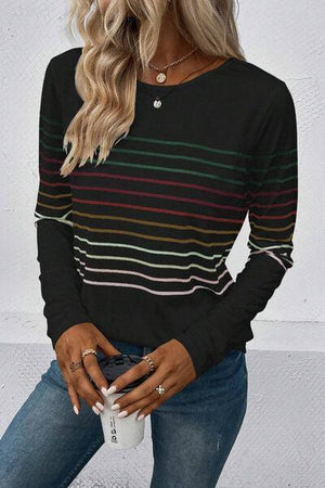 a woman wearing a striped sweater and jeans